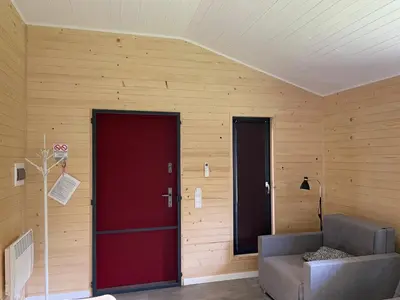 two red doors in a room with a couch at RedDoor Zator Lake Houses in Zator