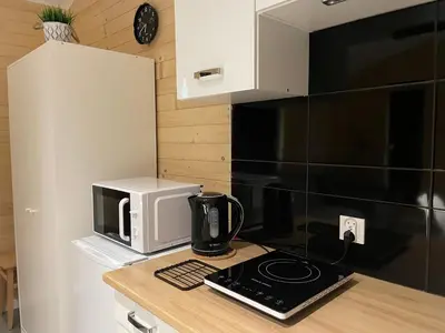 a kitchen with a microwave and a coffee maker on a counter at RedDoor Zator Lake Houses in Zator