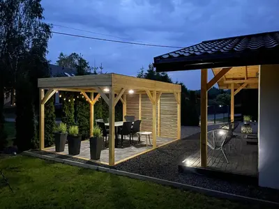 a gazebo with a table in a backyard at RedDoor Zator Lake Houses in Zator