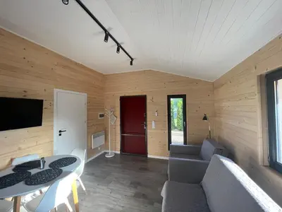 a living room with a couch and a table at RedDoor Zator Lake Houses in Zator