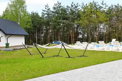 a group of hammocks in the grass in a yard at Domki Łowisko Wieniec in Gdów