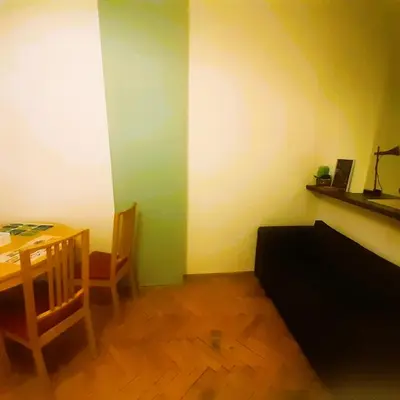 a room with a table and a table and a chair at Floriańska NewTown in Kraków