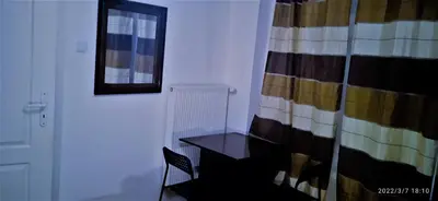 a room with a table and a window and a curtain at Floriańska NewTown in Kraków