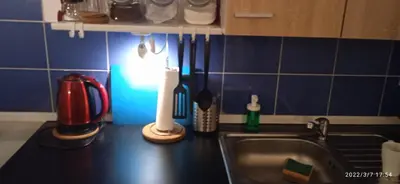 a kitchen counter with a sink and utensils at Floriańska NewTown in Kraków