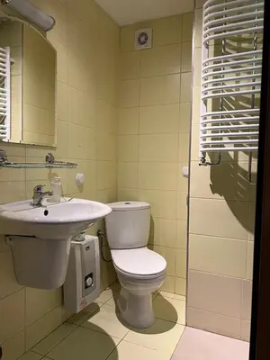 a bathroom with a toilet and a sink at Garbarska 22 Aparthotel in Kraków