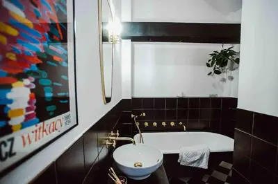 a bathroom with a tub and a toilet and a sink at HAPPY MOMENTS APARTMENTS in Kraków