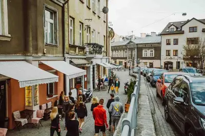 a group of people walking down a city street at HAPPY MOMENTS APARTMENTS in Kraków