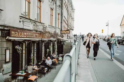 a group of people walking down a city street at HAPPY MOMENTS APARTMENTS in Kraków