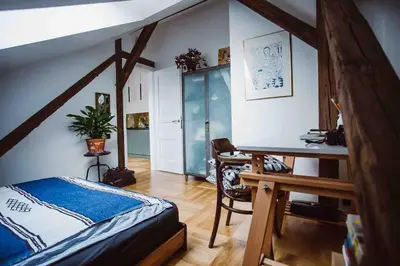 a bedroom with a bed and a desk in a room at HAPPY MOMENTS APARTMENTS in Kraków