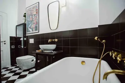 a bathroom with a tub and a toilet and a sink at HAPPY MOMENTS APARTMENTS in Kraków