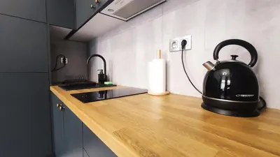 a black tea kettle sitting on a kitchen counter at Starowislna 43 by Homeprime in Kraków