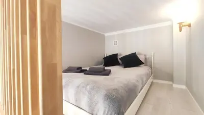 a bedroom with a bed with black pillows on it at Starowislna 43 by Homeprime in Kraków