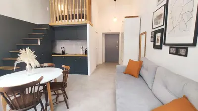 a living room with a couch and a table at Starowislna 43 by Homeprime in Kraków
