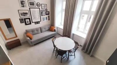 a living room with a table and a couch at Starowislna 43 by Homeprime in Kraków