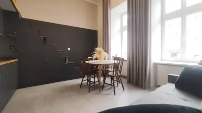 a dining room with a table and chairs at Starowislna 43 by Homeprime in Kraków