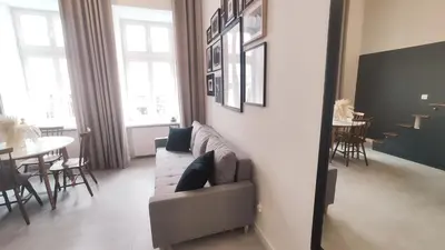 a living room with a couch and a dining room at Starowislna 43 by Homeprime in Kraków