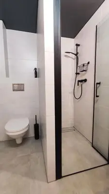 a white bathroom with a toilet and a shower at Starowislna 43 by Homeprime in Kraków