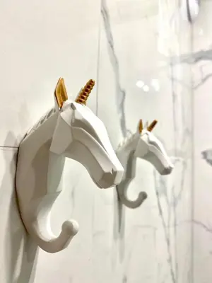 two white horse heads hanging on a wall at Luxury Panda Apartment in Old Town in Kraków