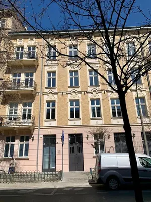 a van parked in front of a large building at Luxury Panda Apartment in Old Town in Kraków