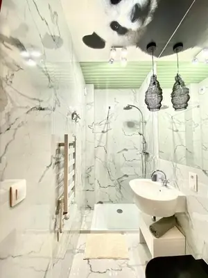 a white bathroom with a sink and a bath tub at Luxury Panda Apartment in Old Town in Kraków