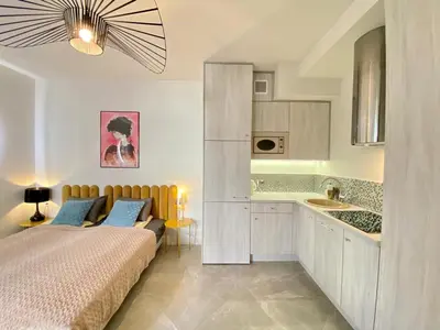 a bedroom with a bed and a sink in it at Luxury Panda Apartment in Old Town in Kraków