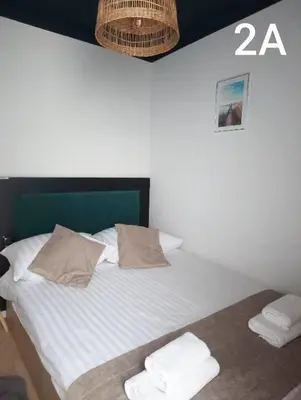a bed with a green headboard and two pillows at Słoneczne Zacisze Las obok Zatora in Las