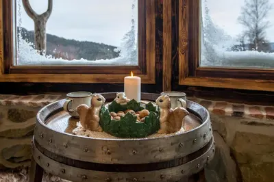 a candle in a wine barrel with animals on it at Domek Hobbita z jaskinią SPA - Osada Jaworzyny in Tokarnia