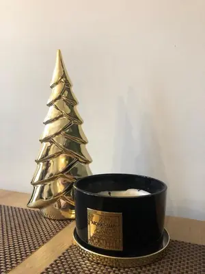 a candle and a christmas tree on a table at Glamorous Apartment Old Town Cracow in Kraków