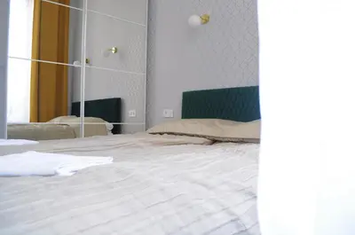 a bedroom with a large white bed with a mirror at Glamorous Apartment Old Town Cracow in Kraków
