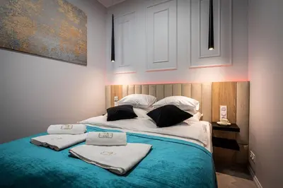 a bedroom with a bed with towels on it at Dasto Apartments Old Town Kraków in Kraków