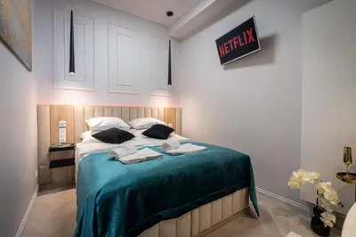 a bedroom with a bed with two towels on it at Dasto Apartments Old Town Kraków in Kraków
