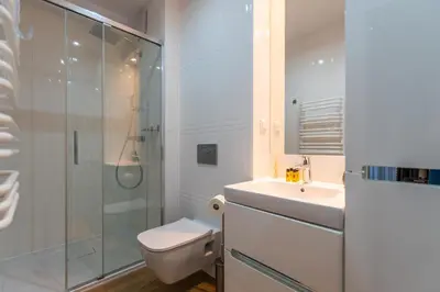 a bathroom with a toilet and a sink and a shower at City Lights Kazimierz in Kraków