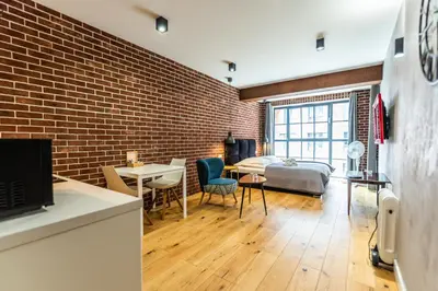 a room with a bed and a brick wall at City Lights Kazimierz in Kraków