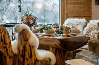 a table with cups of coffee on top of it at Baśniowy Domek Groń z Jaskinią SPA - Osada Jaworzyny in Tokarnia