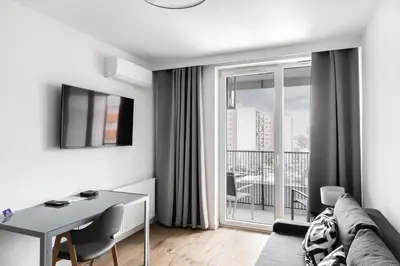 a living room with a couch and a glass table at Apartamenty Platinex 6 in Kraków