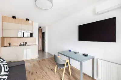 a kitchen with a sink and a microwave at Apartamenty Platinex 6 in Kraków