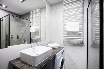 a bathroom with a glass shower with a toilet at Apartamenty Platinex 6 in Kraków