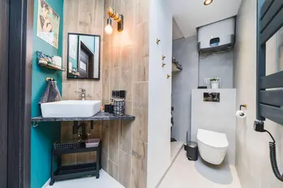 a bathroom with a sink and a toilet at Zender Kazimierz Apartment in Kraków