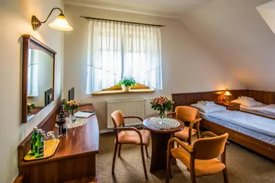 a hotel room with a bed and a table and chairs at Gościniec Na Rozdrożu in Libiąż