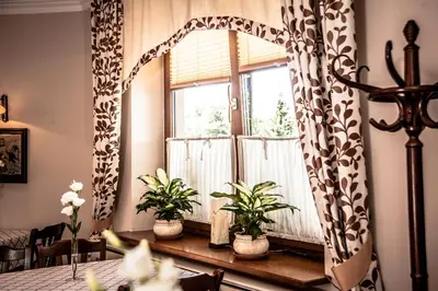 a room with a window with plants on a table at Gościniec Na Rozdrożu in Libiąż