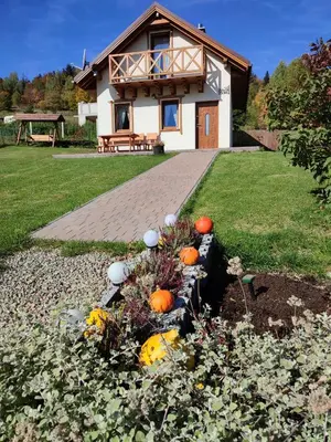 a house with a bunch of pumpkins in a garden at Słoneczna Chałupka in Zawoja