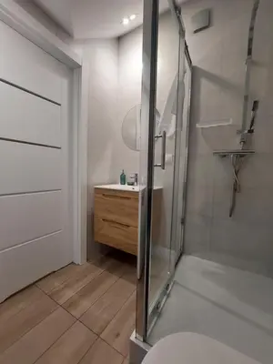 a bathroom with a glass shower and a sink at MR HOME APARTMENTS - Limba in Kraków