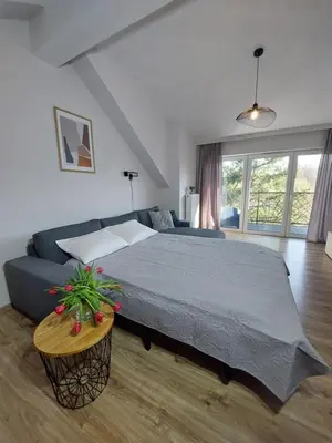a bedroom with a large bed and a couch at MR HOME APARTMENTS - Limba in Kraków