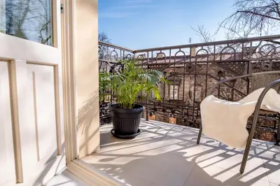 a patio with a plant and a chair on a balcony at Luxury Apartment St. Sebastian in Kraków