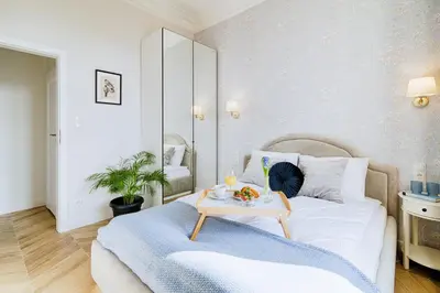 a bedroom with a bed with a tray of food on it at Luxury Apartment St. Sebastian in Kraków
