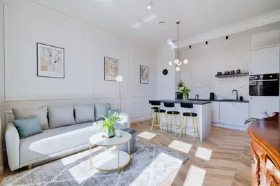 a living room with a couch and a kitchen at Luxury Apartment St. Sebastian in Kraków