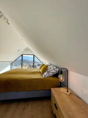 a bedroom with a bed in the middle of a house at Cuda Natury - Niebo, Wiatr, Ziemia in Zawoja