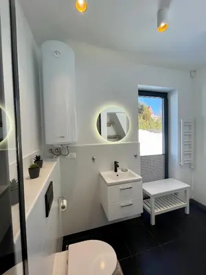a white bathroom with a sink and a toilet at Cuda Natury - Niebo, Wiatr, Ziemia in Zawoja