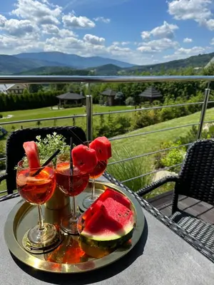 a table with two glasses of watermelon and watermelon at Cuda Natury - Niebo, Wiatr, Ziemia in Zawoja