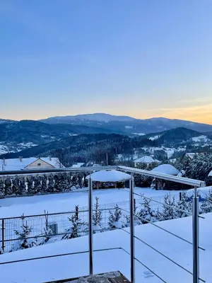 a view of the snow covered mountains from a house at Cuda Natury - Niebo, Wiatr, Ziemia in Zawoja